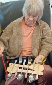 Hazelgrove Court Care Home resident Ann Thompson, 86, playing her homemade xylophone.