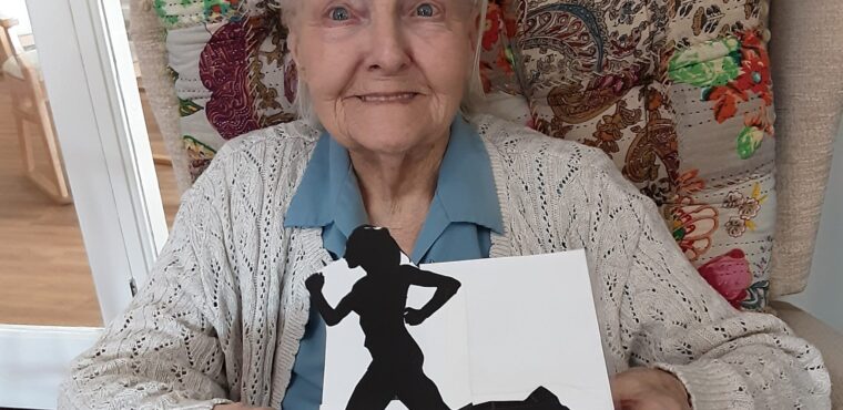 home resident holding Olympic game card